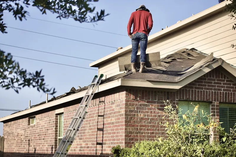 Professional roofer working on a residential roof in Frost Lake